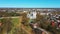 Aerial Shot of Birzai St. John the Baptist Church on the Southern Coast of the Lake Å irvÄ—na in Lithuania, Sunny Spring Day.